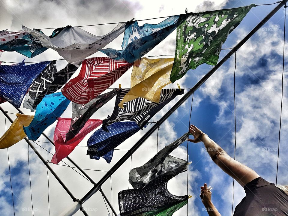 Women hanging out Colourful washing on clothesline beautiful day