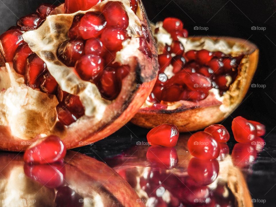 Slices of pomegranate reflections on the surface
