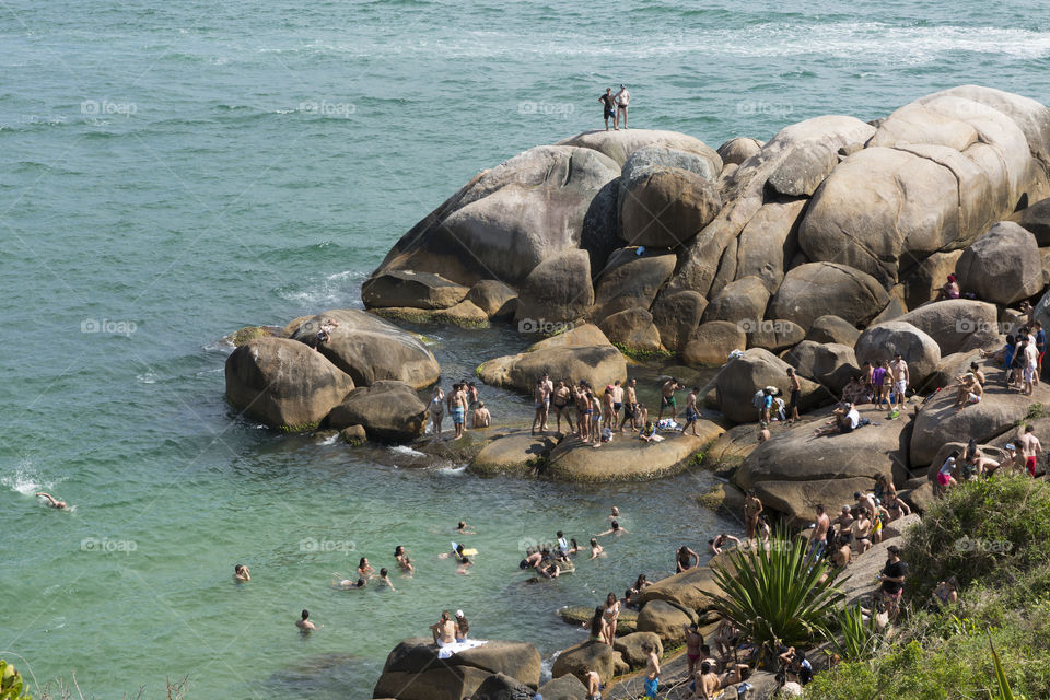 Tourists enjoy the summer in natural pools in Barra da Lagoa in Florianopolis Santa Catarina Brazil.