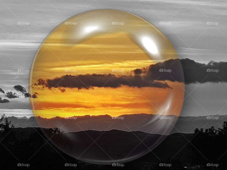 A creation of mine with one of our beautiful sunsets I created a black and white background with full color in a bubble.