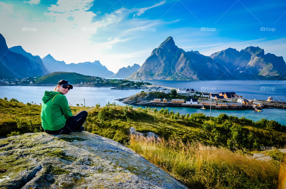 Woman sitting on mountain at Lofoten Island
