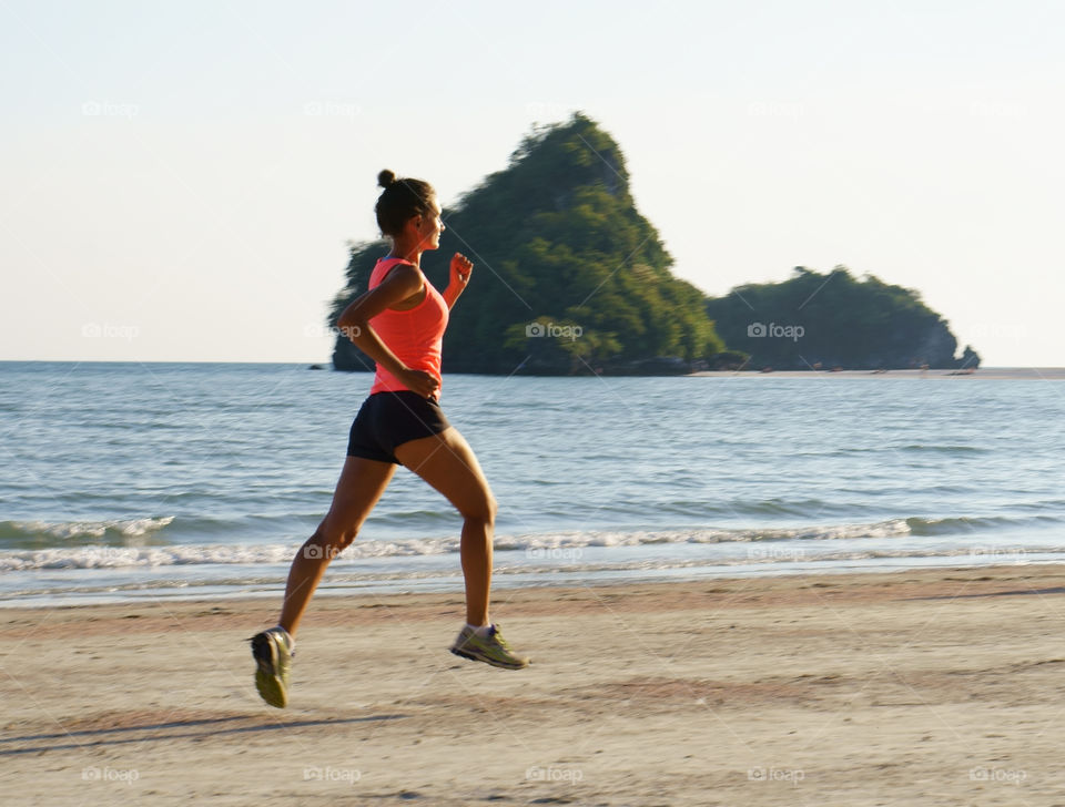 Girl jogging on a beach