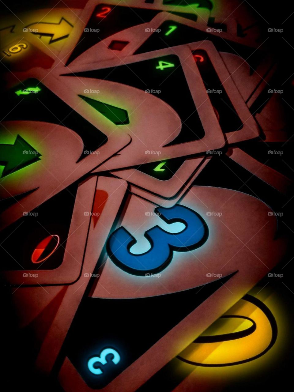 Close-up of a scattered card, with low-key lighting and dramatic color effects