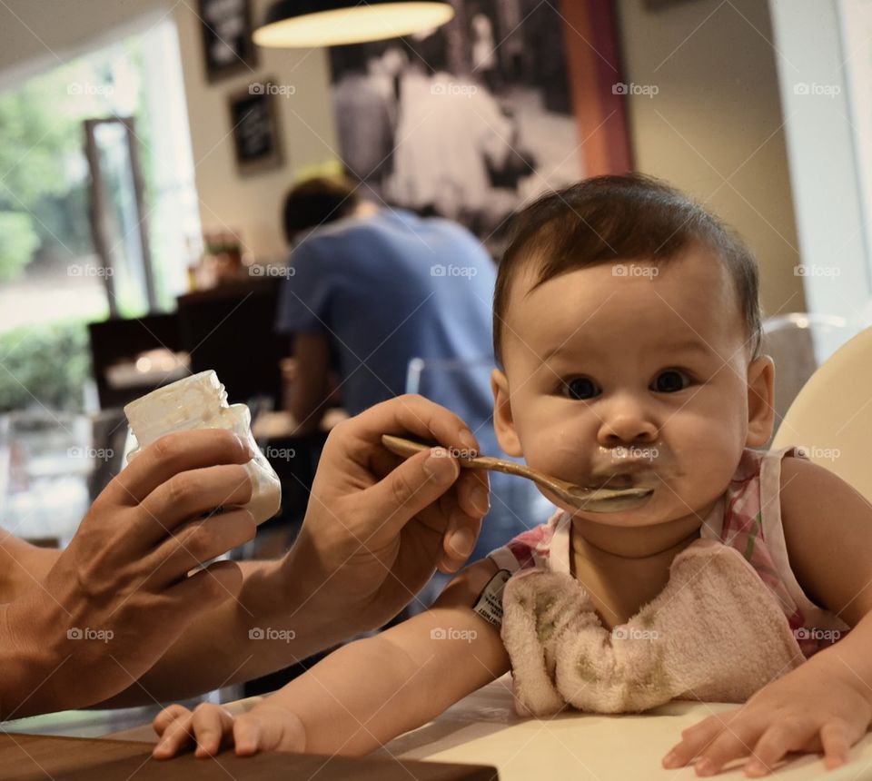 Feeding a beautiful baby girl