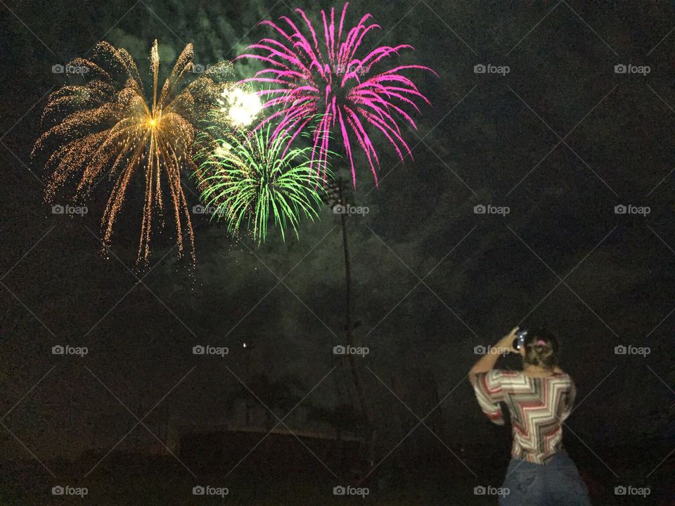 Woman photographing fireworks. Woman photographing fireworks
