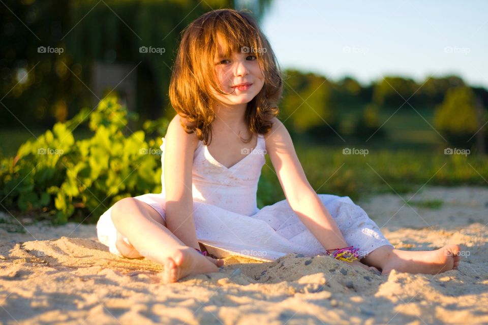 Portrait of a girl sitting on sand
