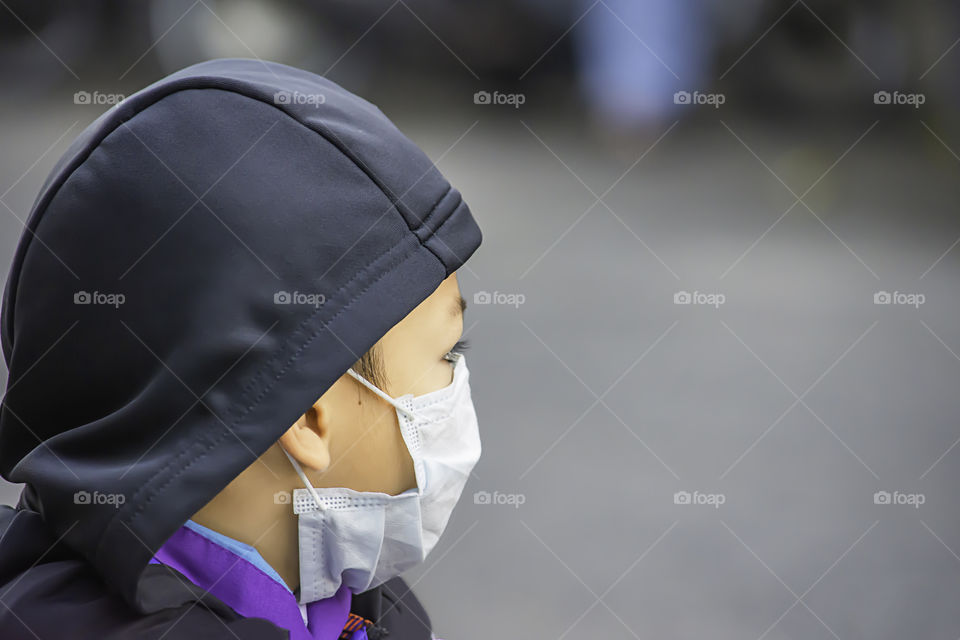 Asean Boys wear a mask to prevent dust in Bangkok ,Thailand.