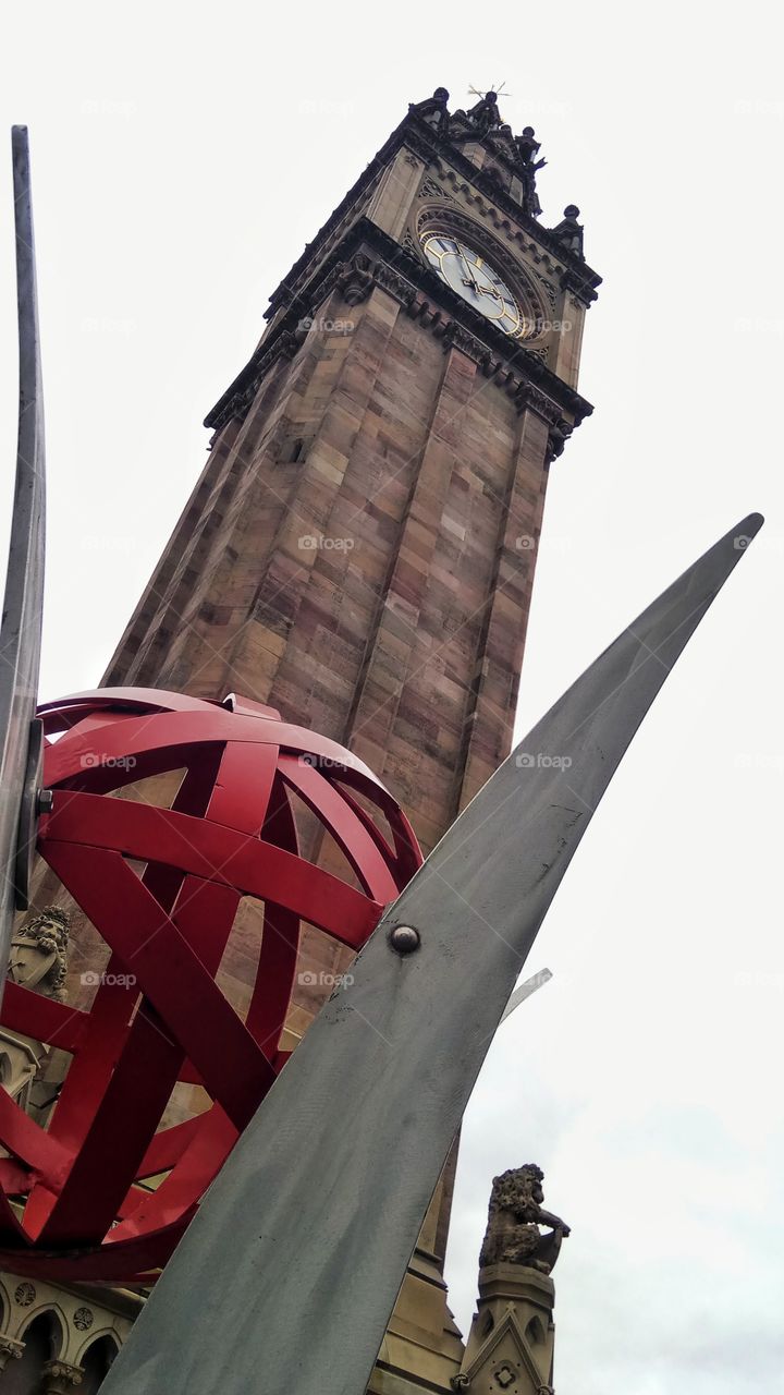 A view of Albert clock from its base in Belfast,Northern Ireland.Beside it stands a modern art piece in unison