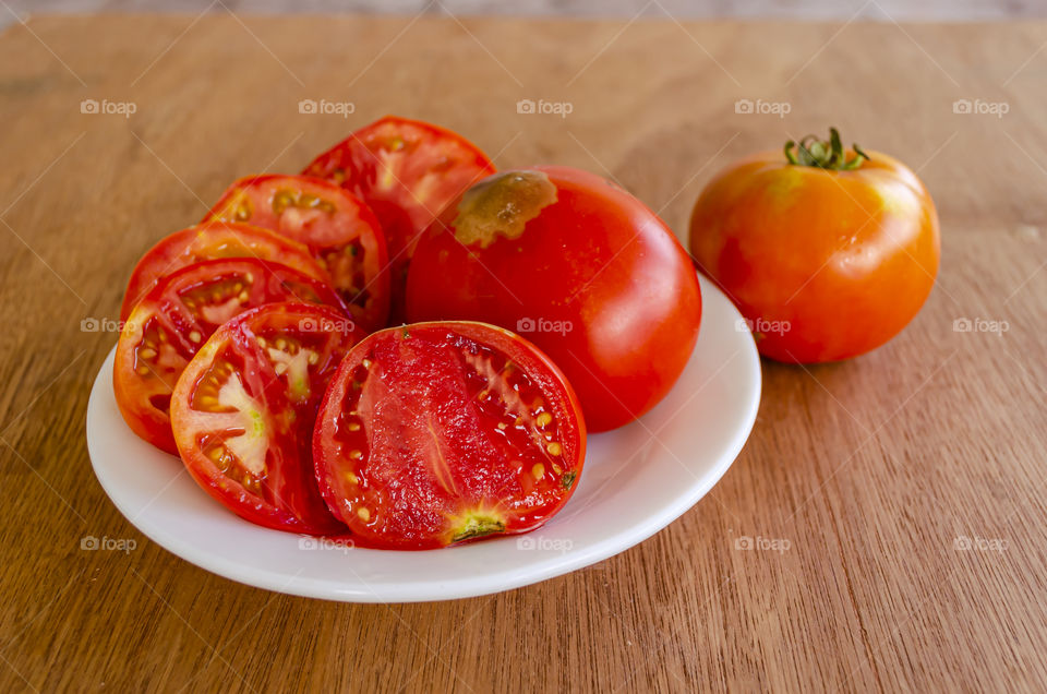 Whole And Slices Of Tomatoes