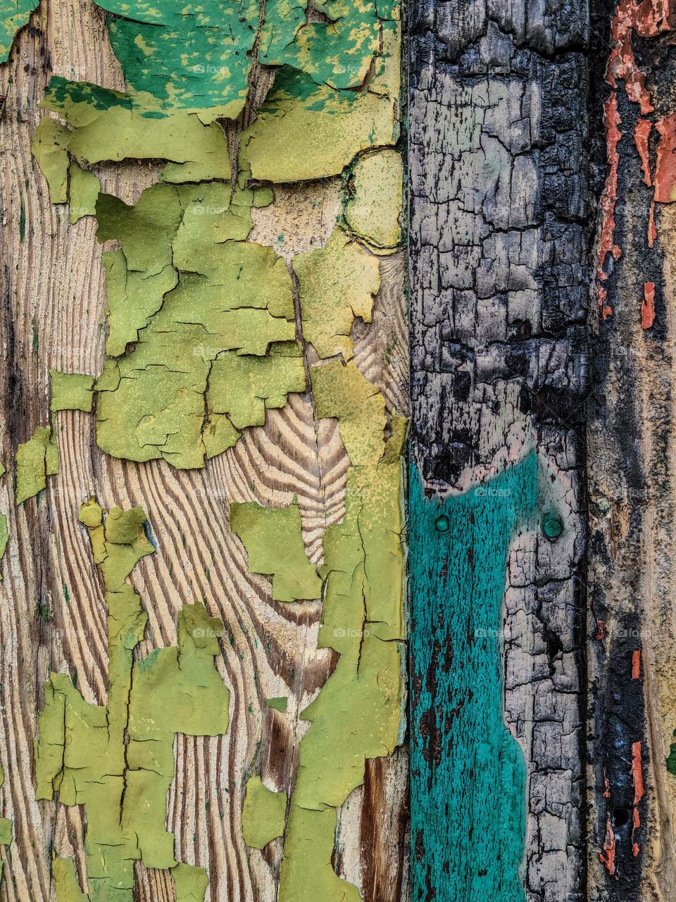 Architectural details of an old abandoned building damaged by fire with paint peeling off the side, decaying with neglect 