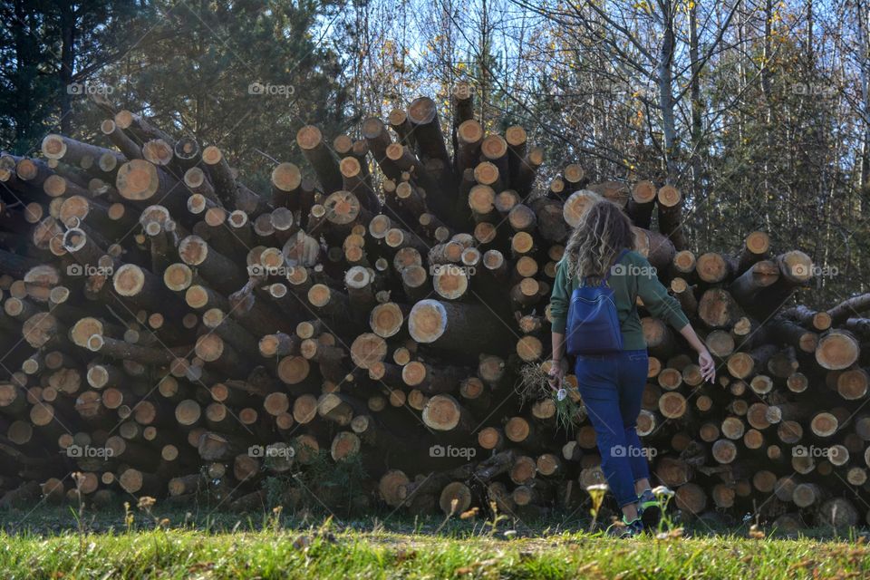 girl resting on a nature cut trees background