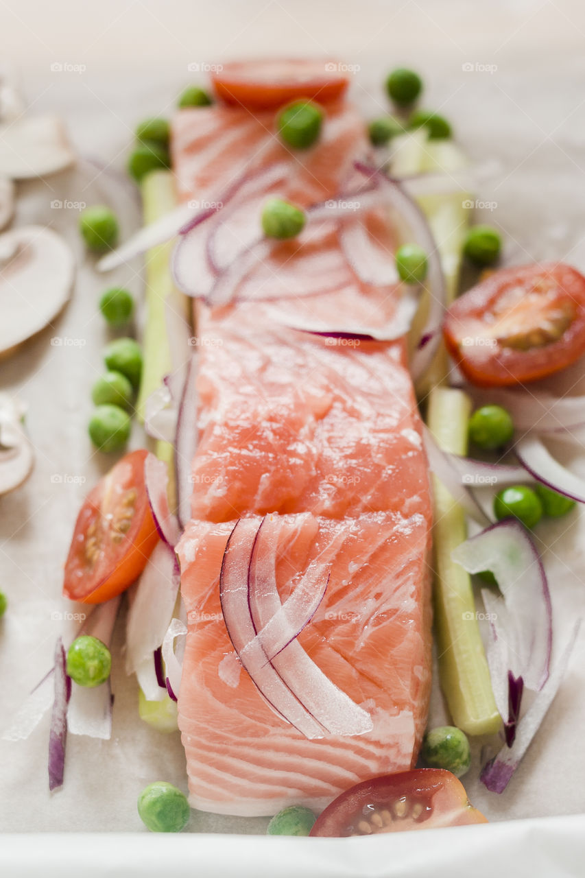 Salmon fillet in parcel. Top view of a parcel (papillon) with a salmon fillet and vegetables ready to be baked.