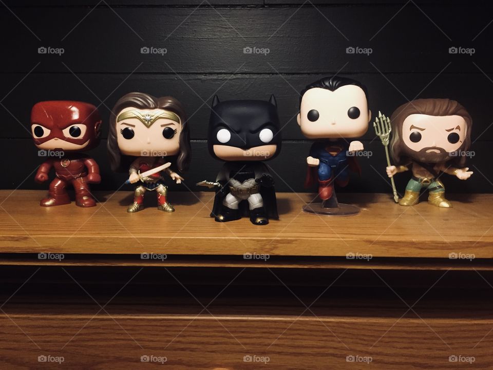 Justice league superhero pop collectibles standing in a row. 