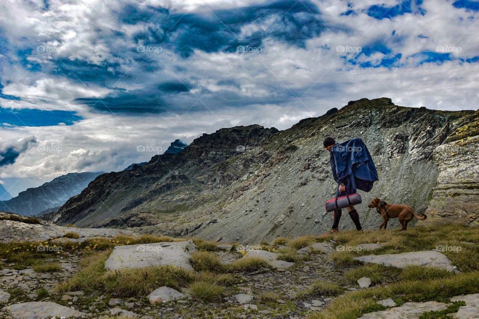 mountain landscape with hiker and dog, italian alps.