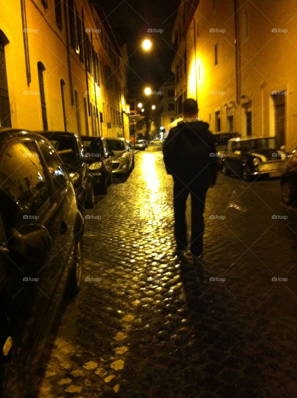 A walk in Rome. A man walking along the street a night in Rome, Italy