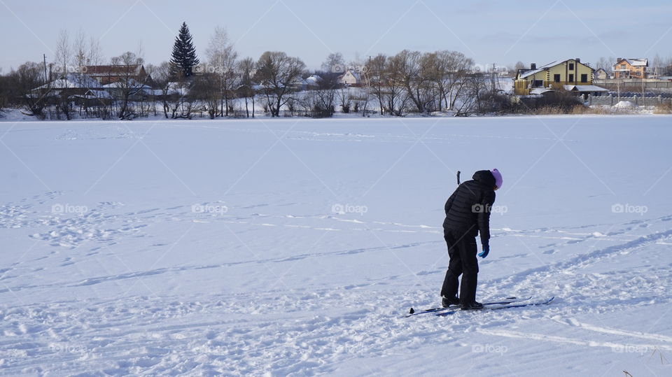 Rear view of man standing in snow
