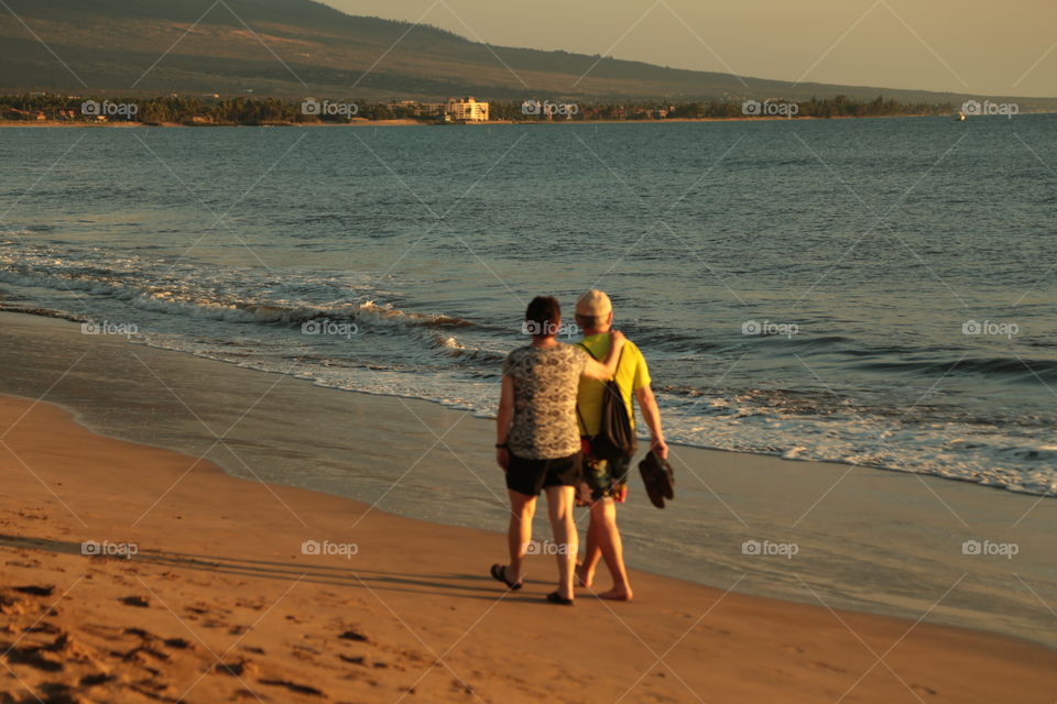 Having a beautiful time walking down the beach.