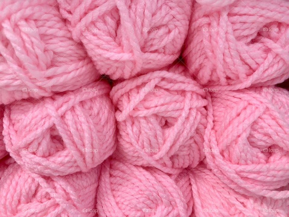 Pink yarn rolls closeup