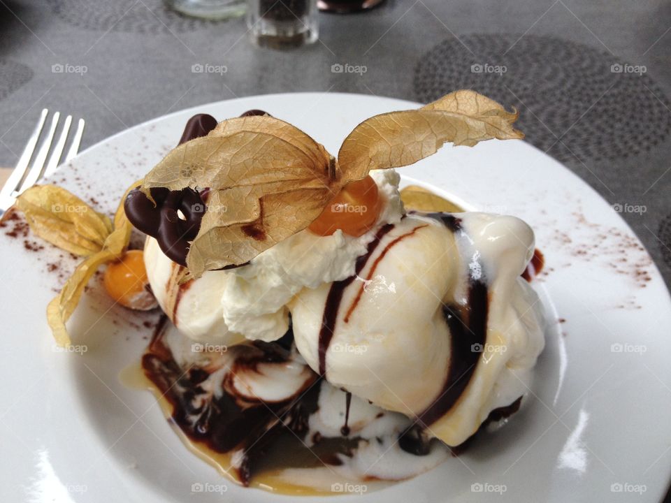 Delectable warm brownie with hot fudge, caramel, ice cream, whipped cream and toasted almonds with a couple of kumquats to cut the sugar overload! Sooooo good!