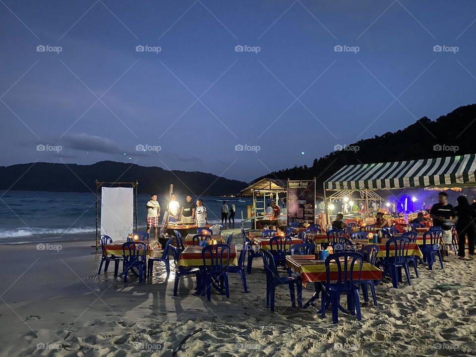 The excitement of the stalls on the beach at night.