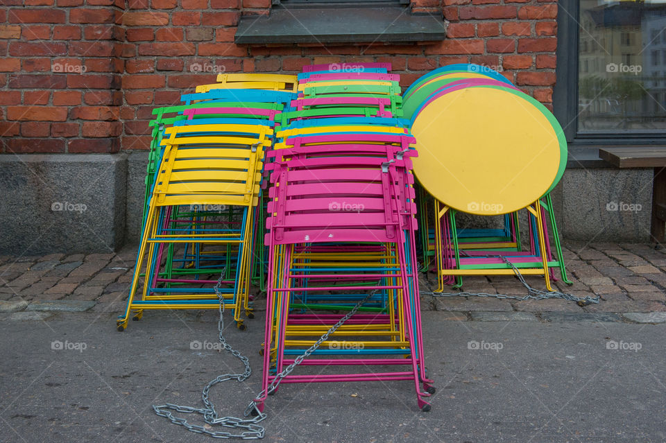 Stacked colorful tables and chairs 