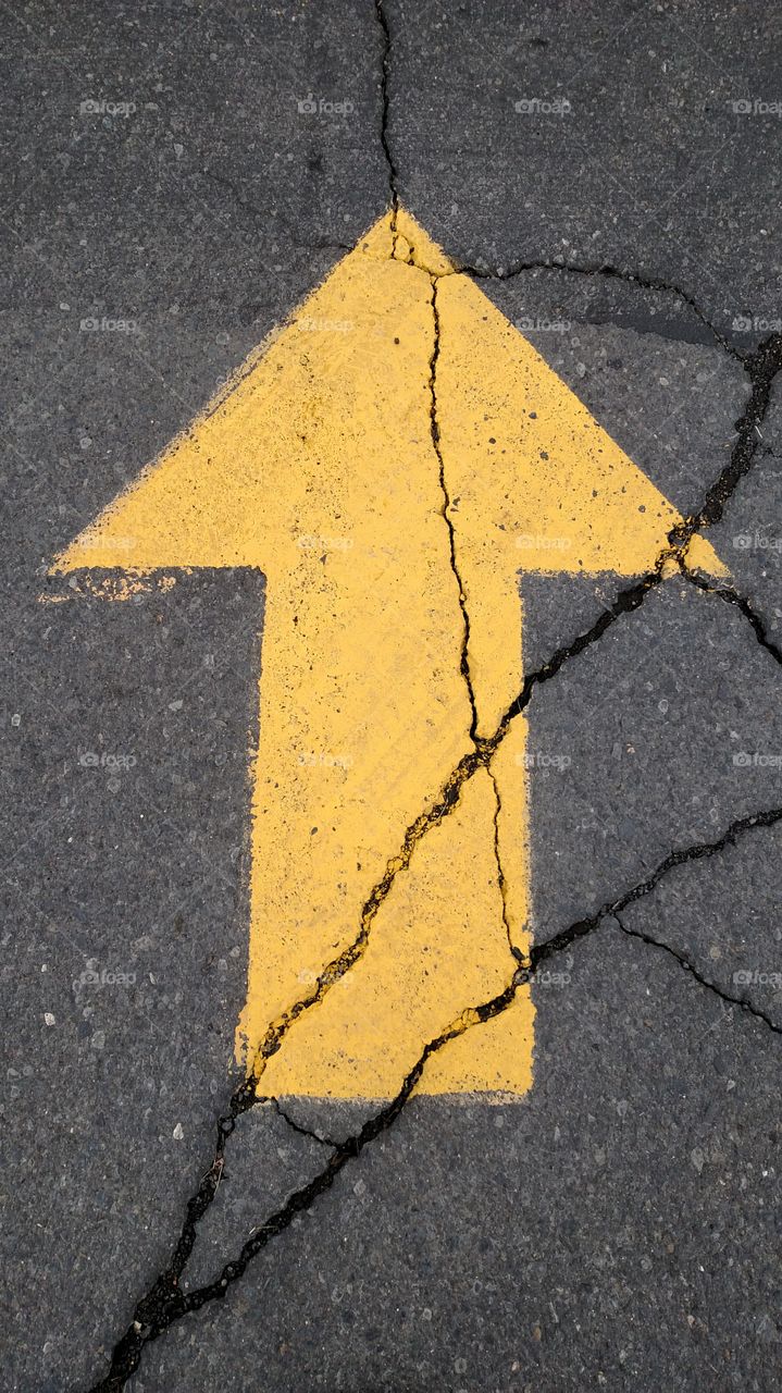 Yellow arrow on concrete.