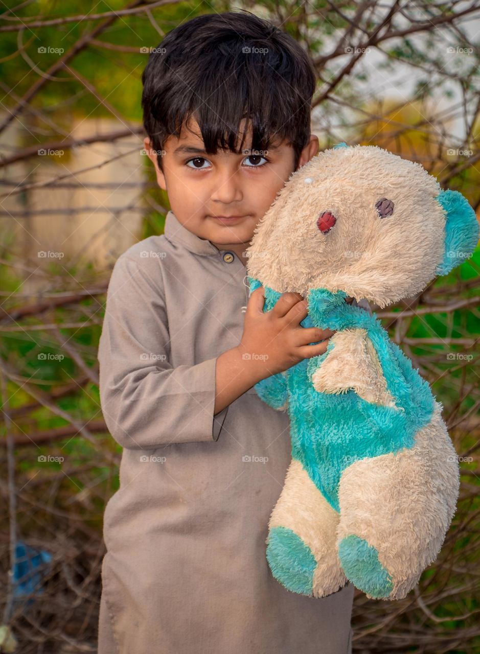 kid play with  fake Bear