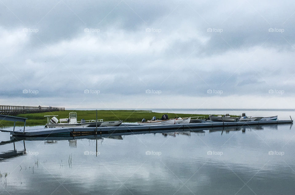 Quiet - catching the beach at a quiet time.  Grey skies keep people away, but the water was as still as a mirror and it was beautiful. 