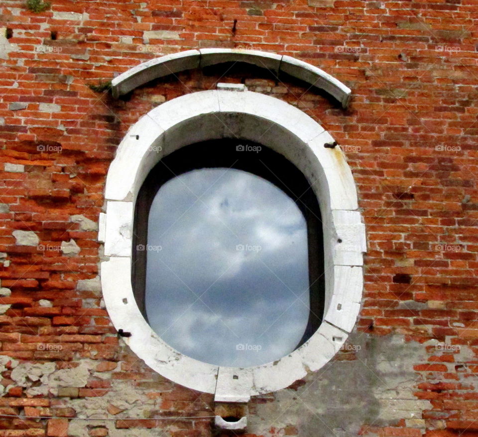 blue sky and clouds reflecting in a window