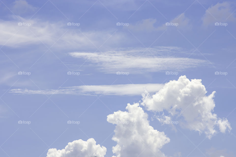 The beauty of the sky with clouds and the sun in summer.