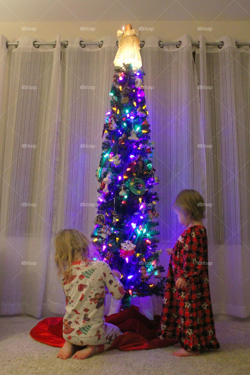 Sisters by Christmas tree