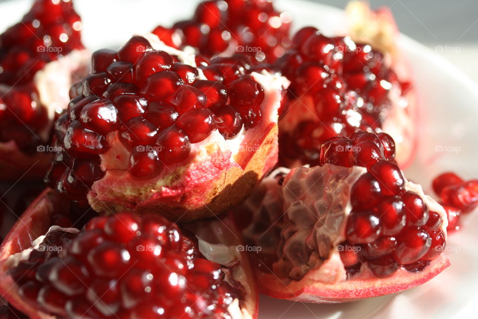 Ruby red juicy arils of ripe pomegranate