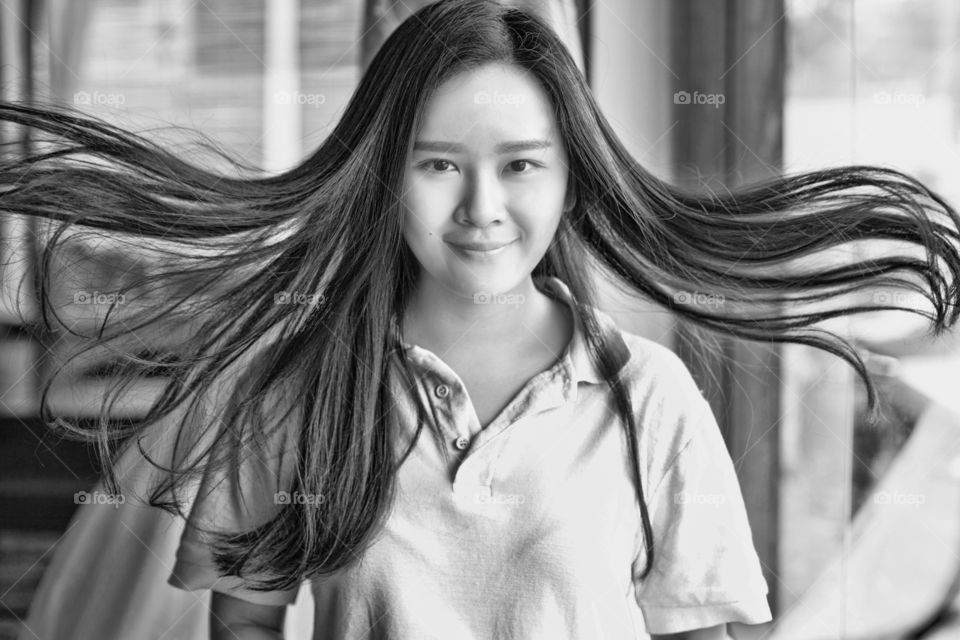 Portrait of a woman with her hair swept by wind