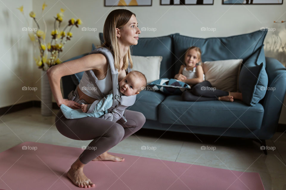 Mommy exercising at home with baby 