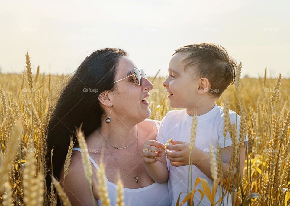 mother and son in wheat field