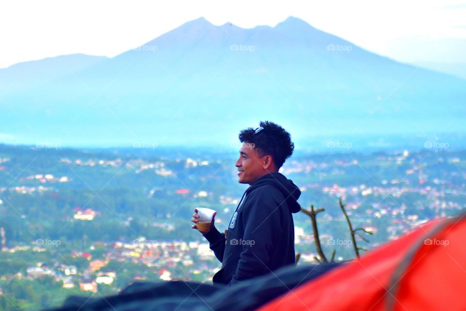 Camping at Puncak Bogor and enjoying the view of Bogor city and Mount Salak in the distance