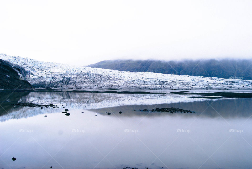 Reflection of snowy mountain on lake