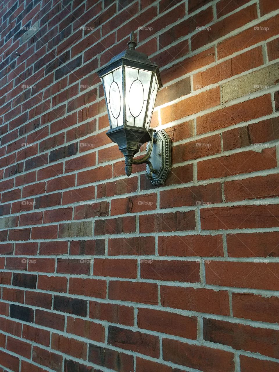 streetlight on brick wall
