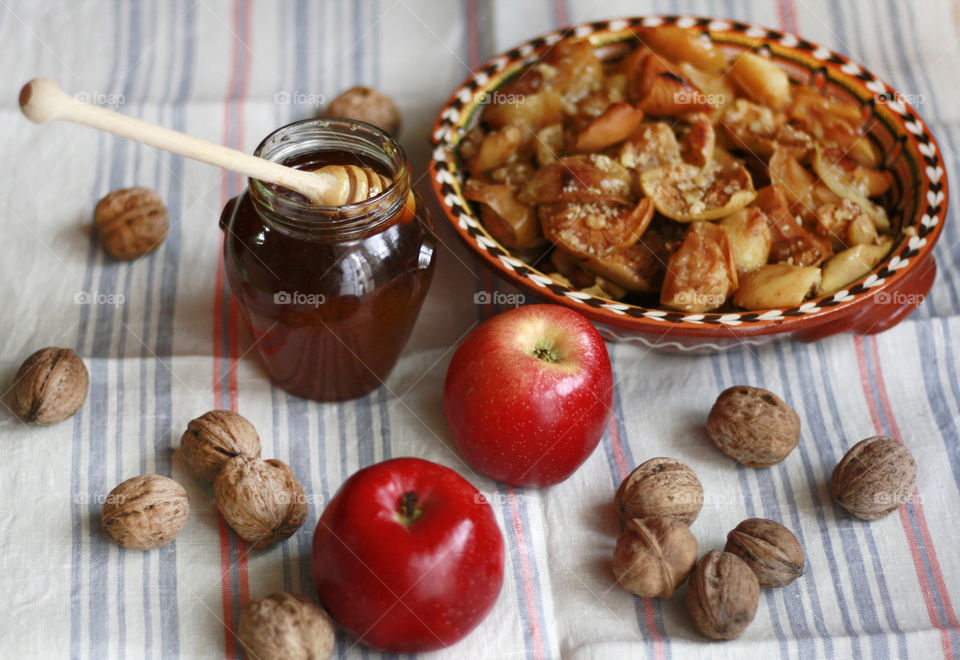 Rustic still life food, cooking at home, baked apples and honey