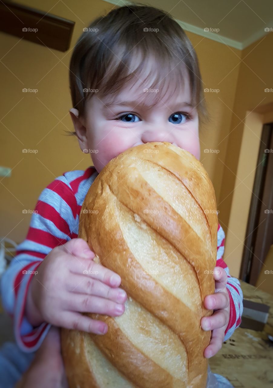 Close-up of a pretty girl eating baked bread