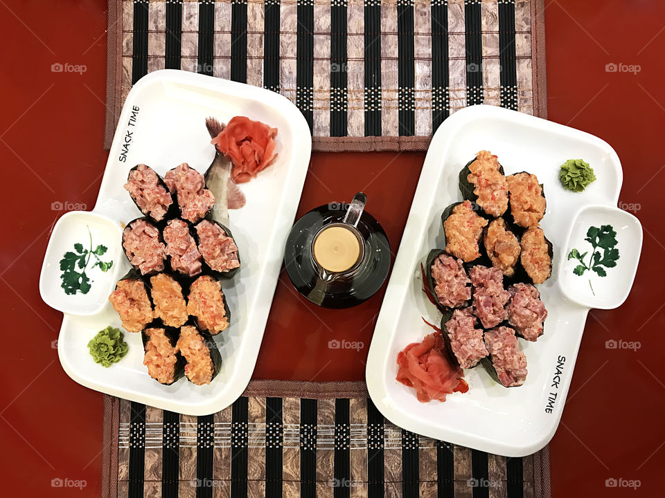 Symmetrical sushi set on red background 