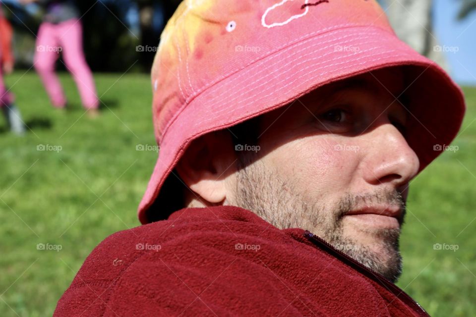 A father wearing his daughter hat