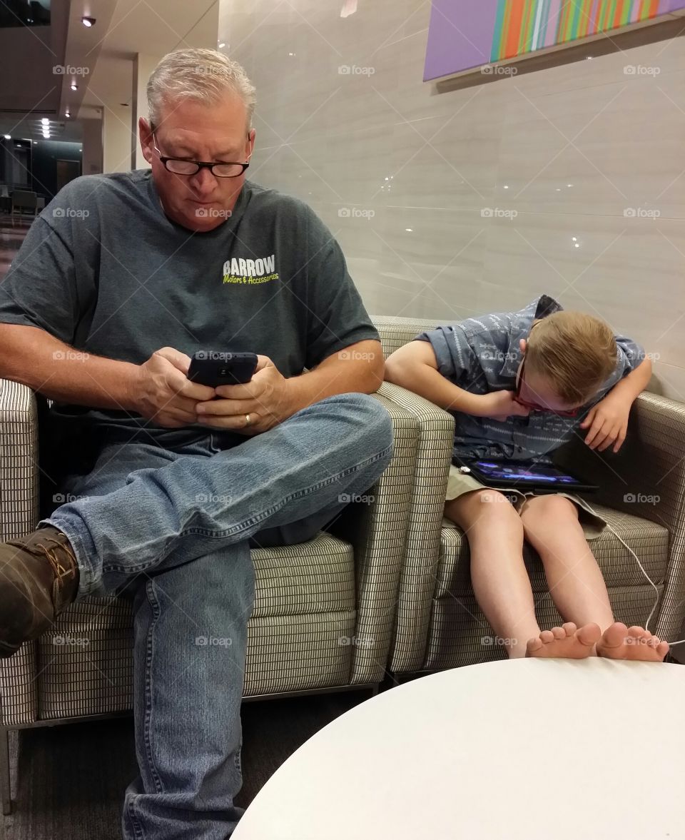 Grandfather and grandson using Smartphone