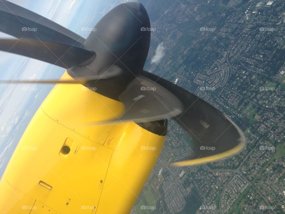 Yellow propellor airplane  airline airborne. Yellow propeller airline airborne 