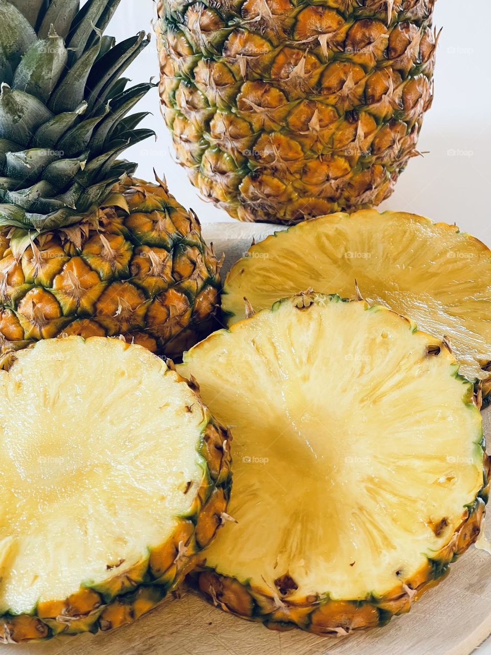 Juicy yellow pineapple slices from above, tropical fruit, Latin American fruit, edible bromeliad 