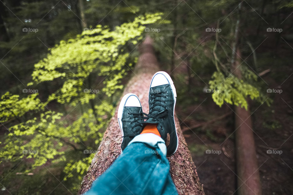 Relaxing In Nature Photo
Shot of legs and crossed feet taking a much deserved break on a fallen tree in the forest.