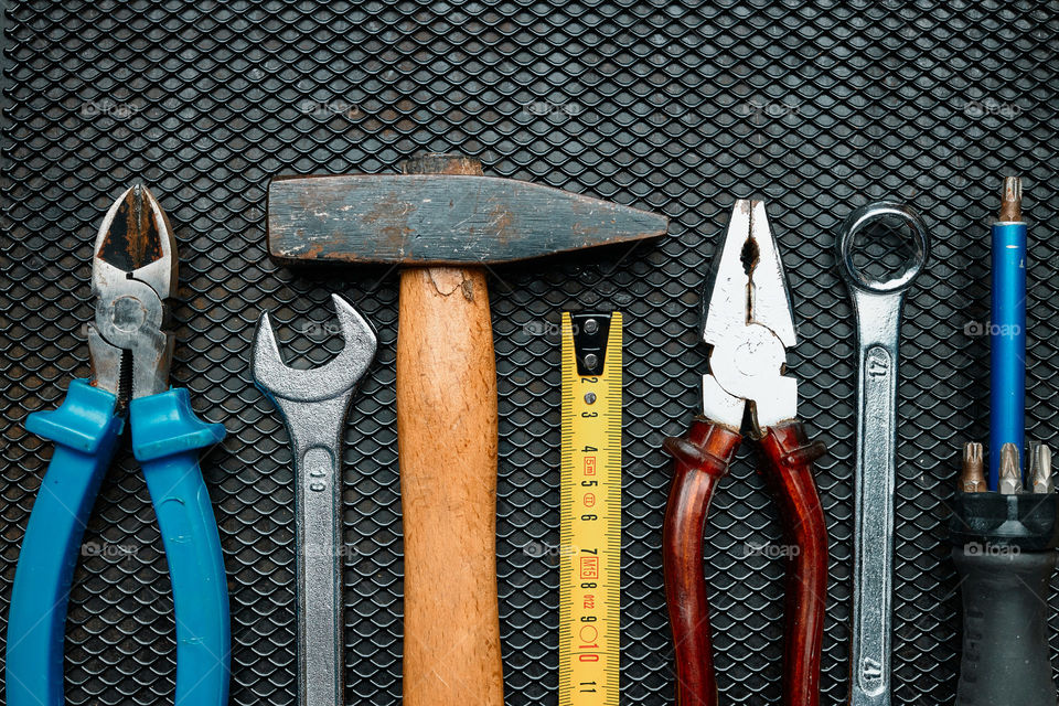 Hardware tools wrench screwdriver tape hammer on steel surface. Mechanic tools for maintenance. Hardware tools to fix. Technical background with copy space