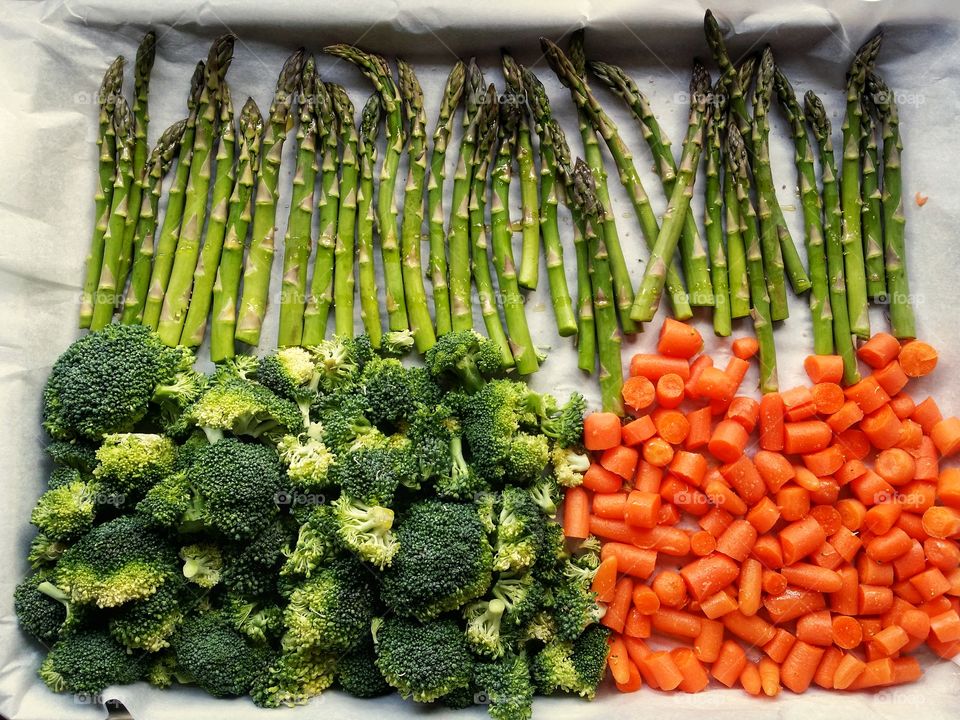 Fresh raw carrots asparagus and broccoli ready to be roasted