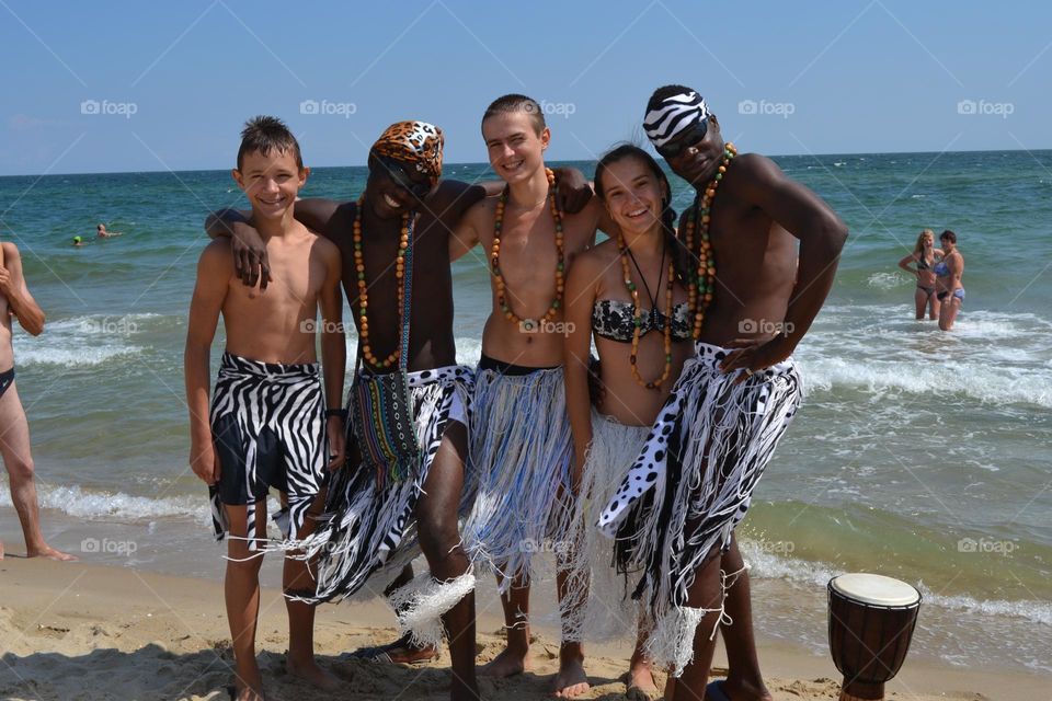 Costume party on the shore of the Black Sea on a sunny day