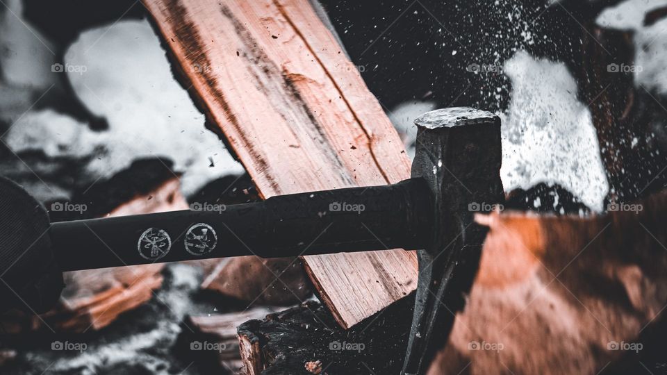 Axe falling straight through wood.